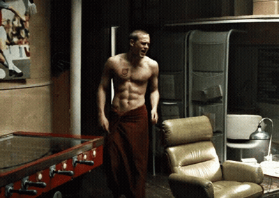 Shirtless Man In Red Towel Standing In Room GIF