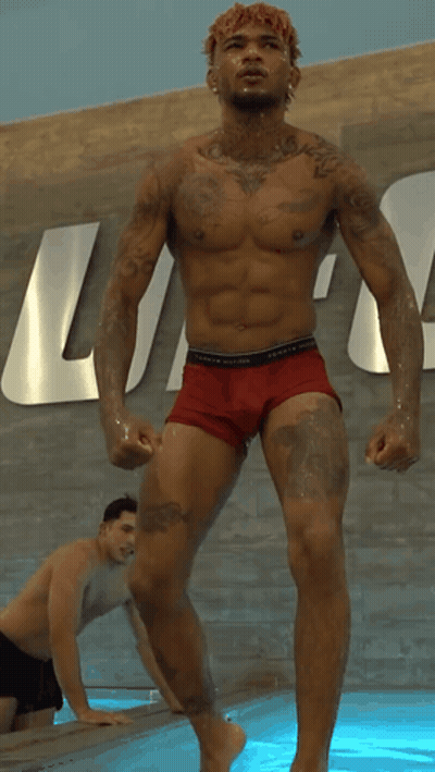 Shirtless Man In Red Underwear In Front Of Tommy Hilfiger Sign GIF
