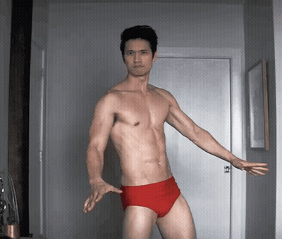 Shirtless Man In Red Underwear Standing By Door GIF