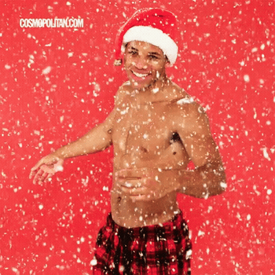Shirtless Man In Santa Hat Standing In Snow GIF