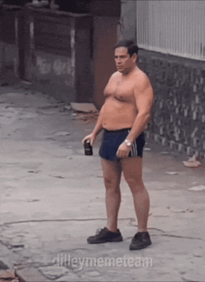 Shirtless Man in Shorts on Sidewalk With Dileymemeteam