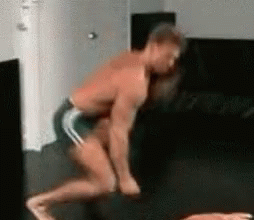 Shirtless Man in Shorts Squatting