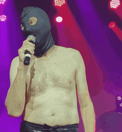 Shirtless Man In Ski Mask Holding Microphone GIF