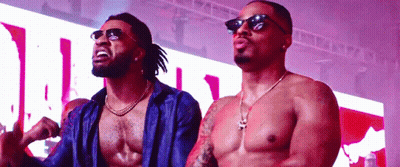 Shirtless Man In Sunglasses Next To Another Man GIF