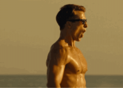 Shirtless Man In Sunglasses Screaming On Beach GIF