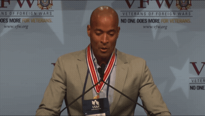 Shirtless Man In Yellow Staff Shirt In Front Of Crowd GIF