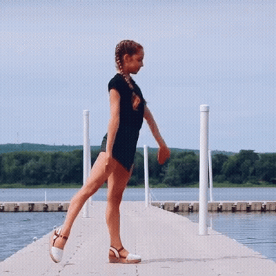Shirtless Man Jumping Holding Tire With TH Letters GIF
