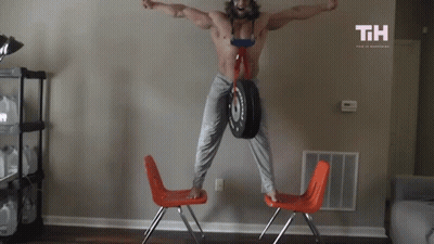 Shirtless Man Jumping Holding Tire With TH GIF