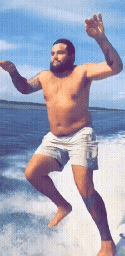 Shirtless Man Jumping Into Water From Boat GIF