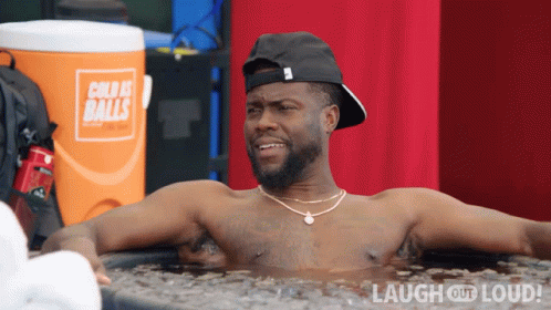Shirtless Man Laying In Tub Of Ice With Orange Cooler Cold As Balls GIF