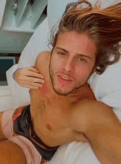 Shirtless Man Laying On Bed Hand On Chest GIF