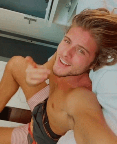 Shirtless Man Laying On Bed Smiling GIF