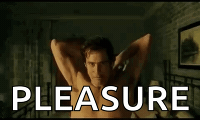 Shirtless Man Laying On Bed With Arms Outstretched Saying Pleasure GIF