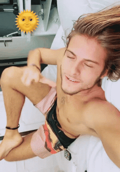 Shirtless Man Laying On Bed With Sun Face GIF