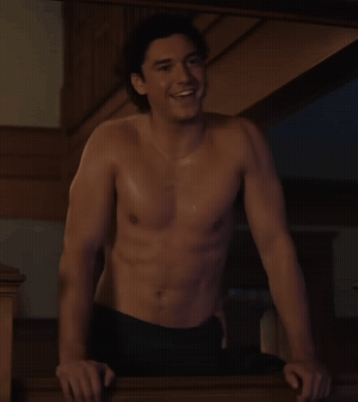 Shirtless Man Leaning On Railing Smiling GIF