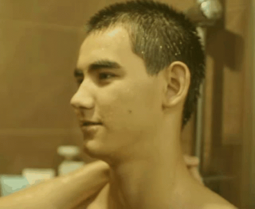 Shirtless Man Looking At Himself In Mirror GIF