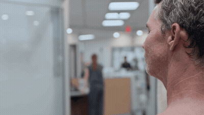 Shirtless Man Looking Out Window GIF