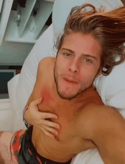 Shirtless Man Lying On Bed Hand On Chest GIF