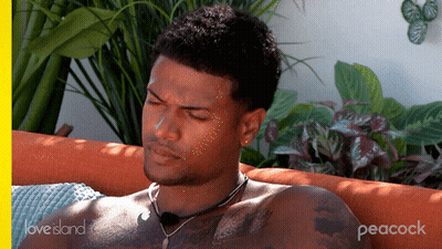 Shirtless Man Lying On Couch With Peacock GIF