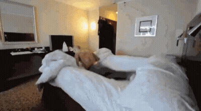 Shirtless Man Lying On Hotel Bed GIF