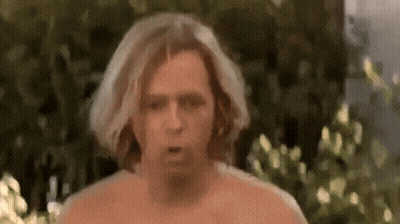 Shirtless Man Making Funny Face In Front Of Bush GIF