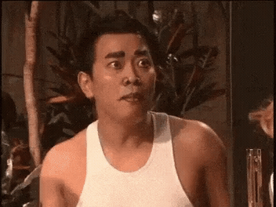 Shirtless Man Making Funny Face In Front Of Plant GIF