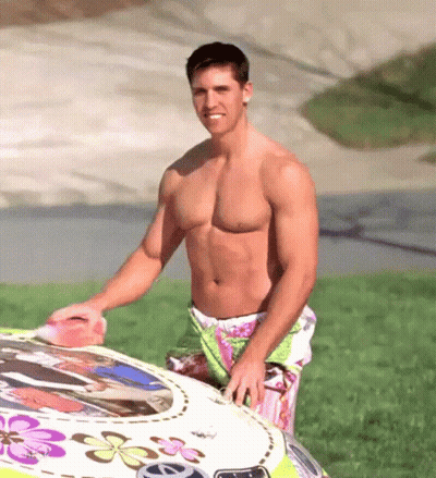 Shirtless Man Next To Car With Flowers GIF