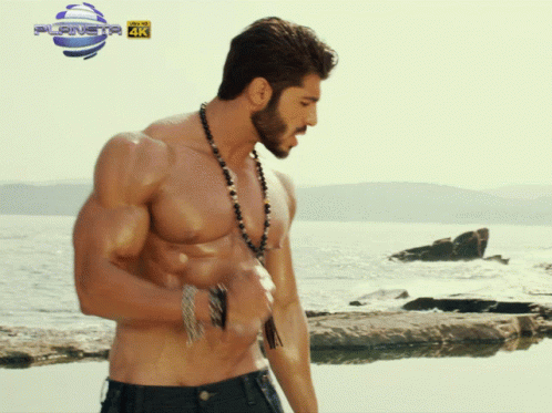 Shirtless Man On Beach In Front Of Planet 4K Sign GIF
