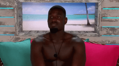 Shirtless Man On Couch By Beach Picture Window GIF