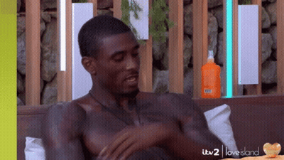 Shirtless Man On Couch With Sunscreen GIF