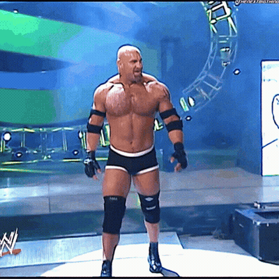 Shirtless Man On Stage In Front Of WWE Sign GIF