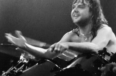 Shirtless Man Playing Drums On Stage GIF