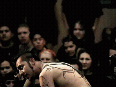 Shirtless Man Playing Guitar For Crowd GIF