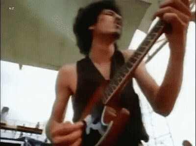 Shirtless Man Playing Guitar On Stage GIF