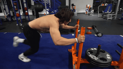 Shirtless Man Pushing Barbell With 45 Plate GIF