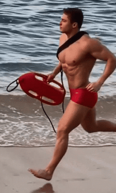 Shirtless Man Red Shorts Running With Life Preserver GIF