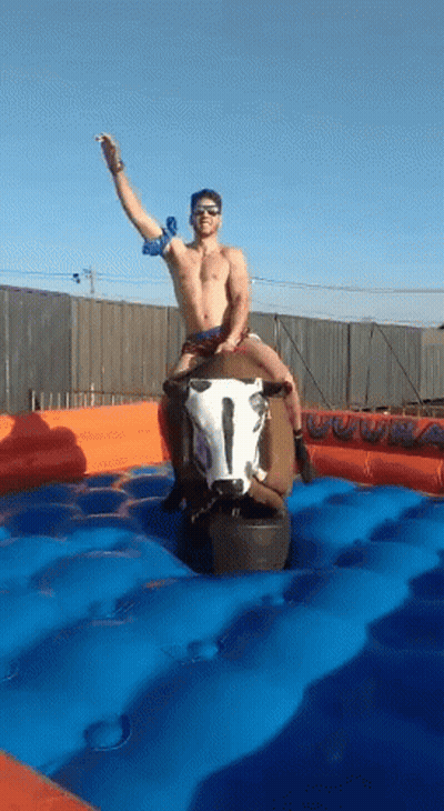 Shirtless Man Riding Mechanical Bull GIF