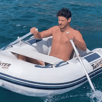 Shirtless Man Rowing Twister Boat In Ocean GIF