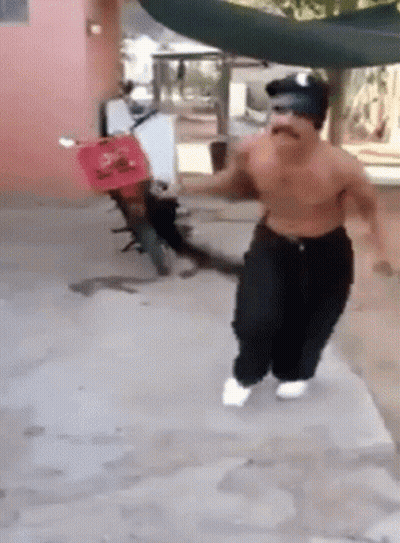 Shirtless Man Running In Front Of Red Scooter GIF
