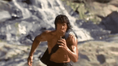 Shirtless Man Running In Front Of Waterfall GIF