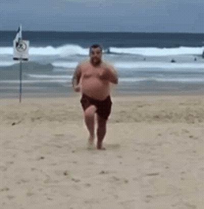 Shirtless Man Running On Beach GIF