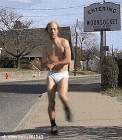 Shirtless Man Running Past Entering Woonsock Sign GIF