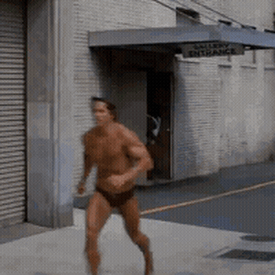 Shirtless Man Running Past Gallery Entrance Sign GIF
