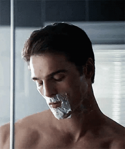 Shirtless Man Shaving Face With Razor GIF