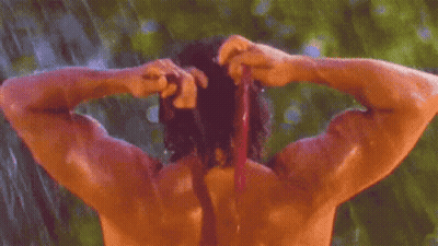 Shirtless Man Showering In Rain And Tying Hair GIF