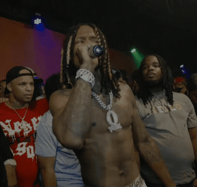 Shirtless Man Singing Into Microphone For Crowd GIF