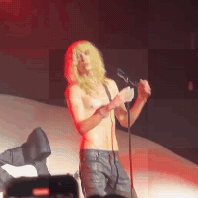 Shirtless Man Singing Into Microphone On Stage GIF
