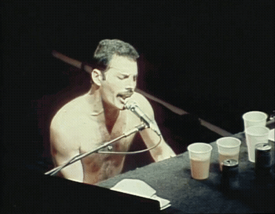 Shirtless Man Singing Into Microphone GIF