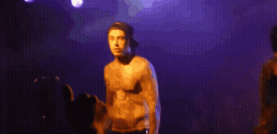 Shirtless Man Singing Into Microphone Purple Background GIF