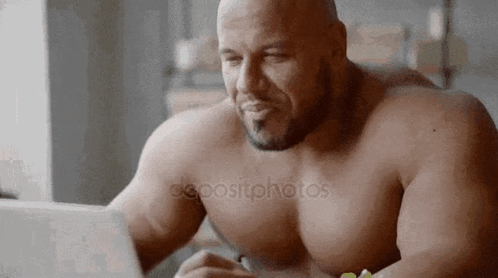 Shirtless Man Sitting At Table Using Laptop GIF